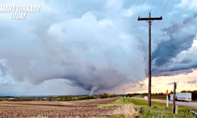 Tornado aftermath in Omaha suburbs with damaged homes and uprooted trees.