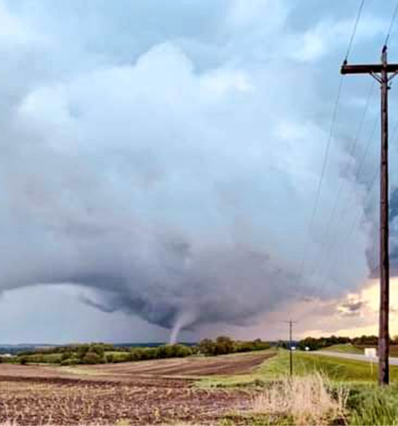 Tornado aftermath in Omaha suburbs with damaged homes and uprooted trees.