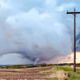 Tornado aftermath in Omaha suburbs with damaged homes and uprooted trees.